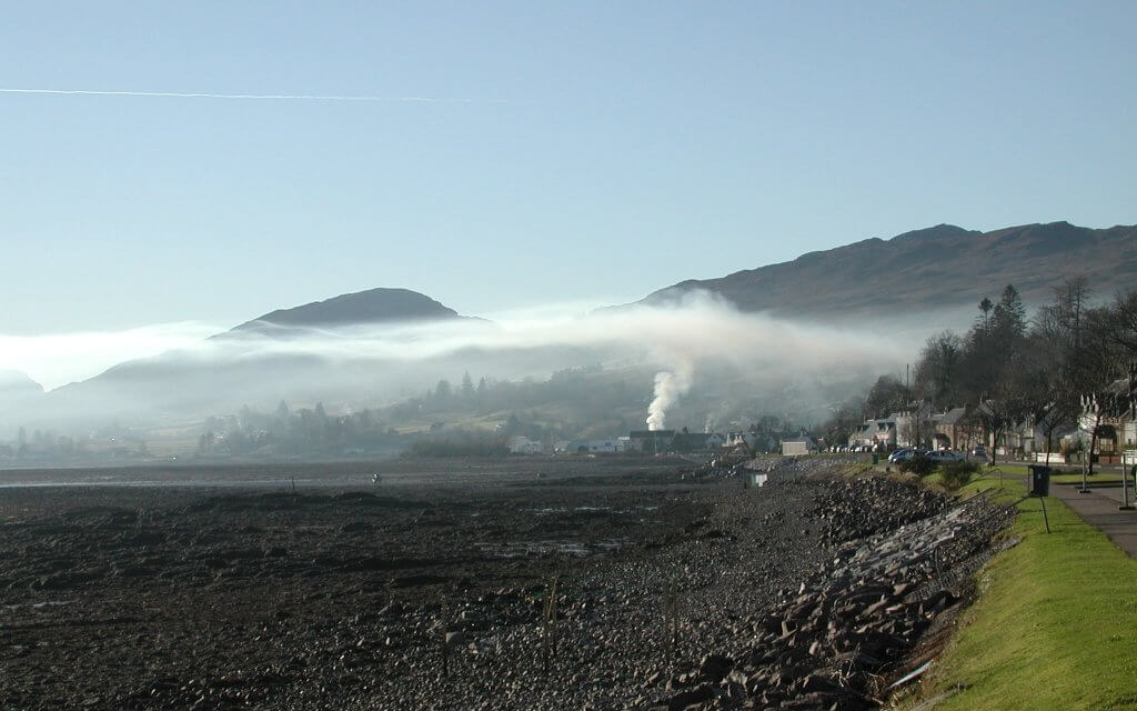 Rising smoke in Lochcarron (Scotland) forms a ceiling over the valley due to a temperature inversion.